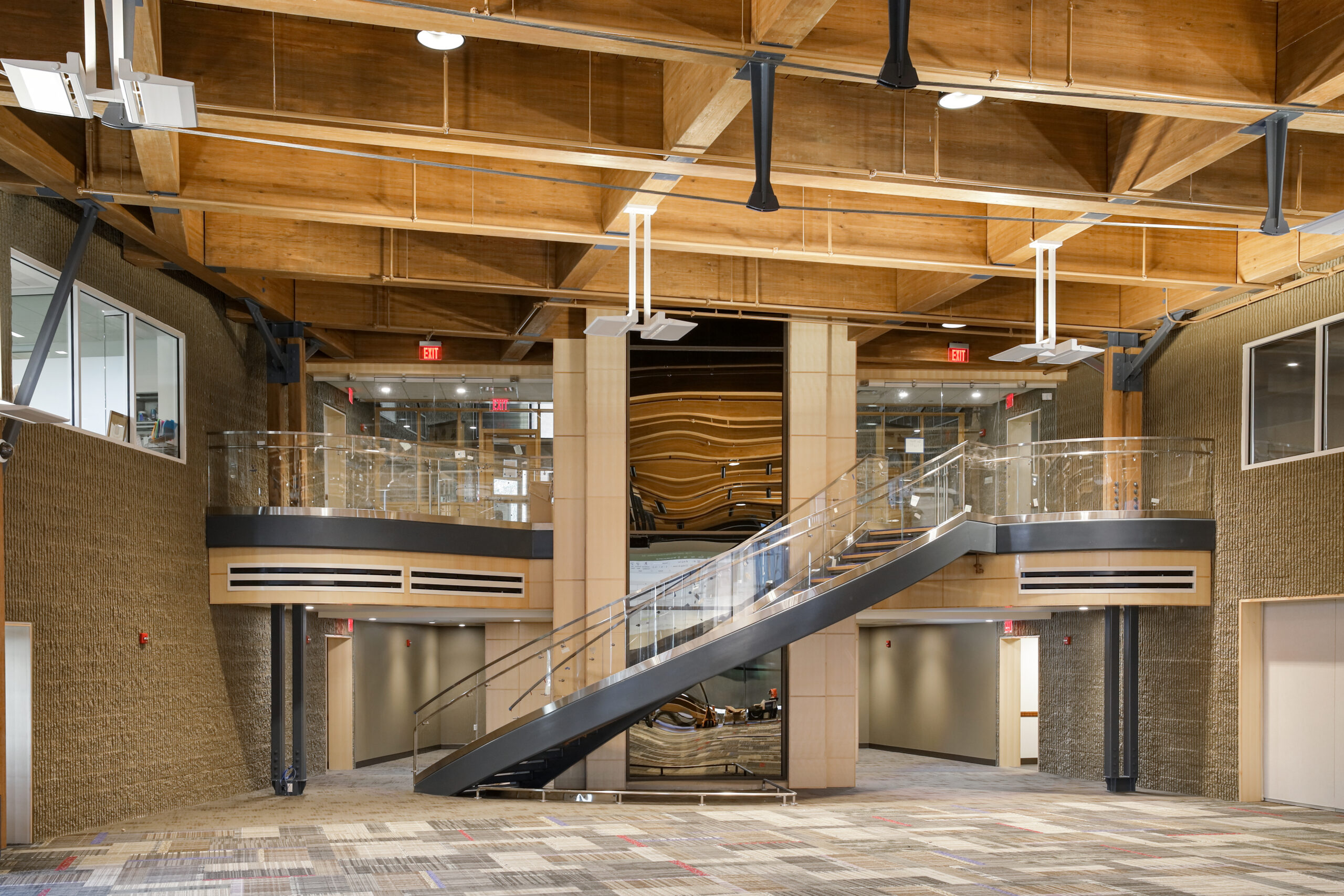 Two curved seating booths with round tables and chairs in a modern office space.
