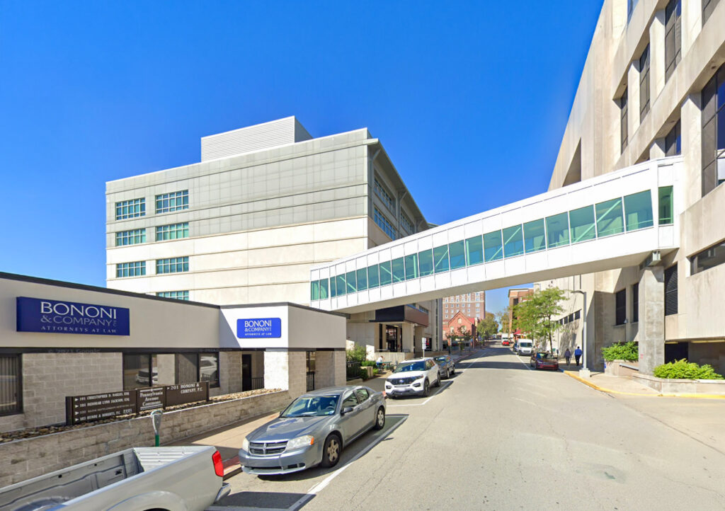 Street view of the Bononi & Company law office building connected to an adjacent structure by an elevated glass walkway.