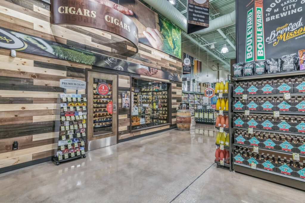 Interior of a store featuring a walk-in cigar humidor on the left and metal shelves stocked with Boulevard Brewing Company beer on the right.