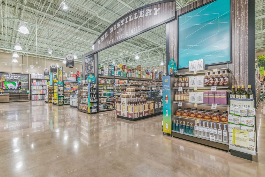 Interior of a liquor store featuring shelves of spirits, with a signage header reading “The Distillery @ Total Wine & More.”