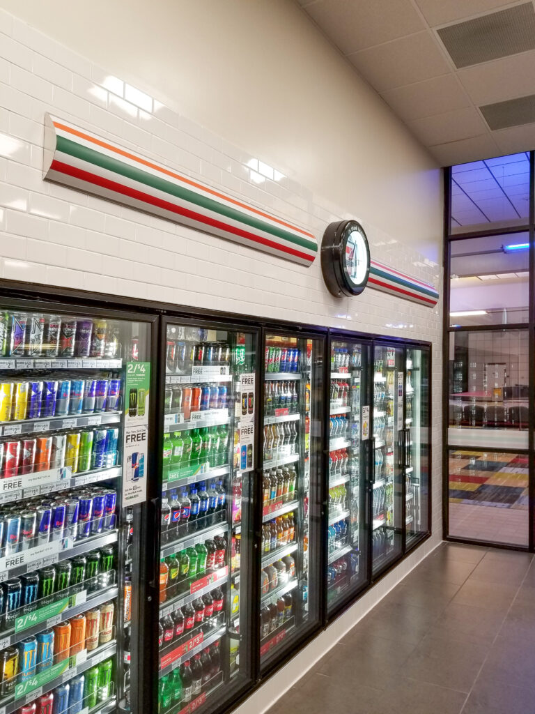 Wall-to-wall beverage coolers in a 7-Eleven store.