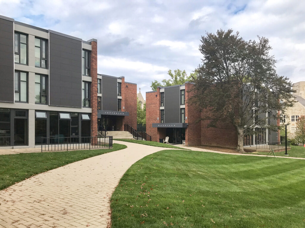 A paved path leads between two multi-story residence halls labeled Jefferson and Harrison.