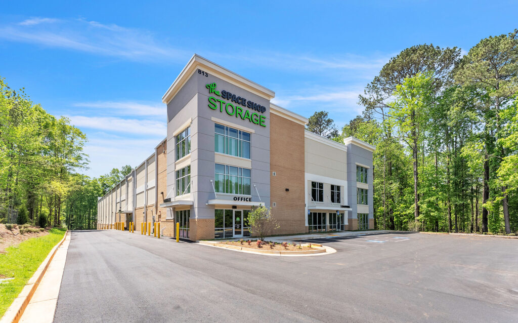 Exterior view of a multi-story The Space Shop Storage building with an office entrance.