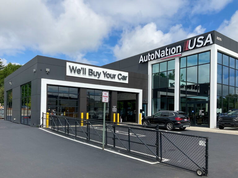 AutoNation USA dealership building with a sign that reads, “We’ll Buy Your Car.”