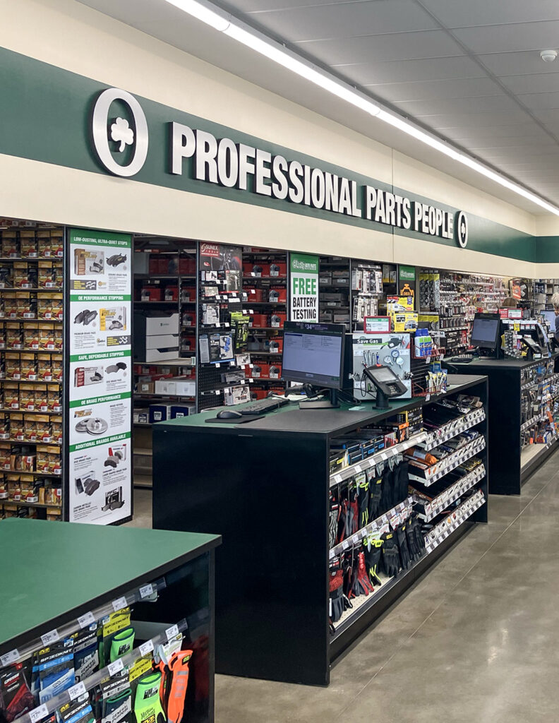 Interior of an O’Reilly Auto Parts store featuring service counters, shelving stocked with automotive products, and a “Professional Parts People” sign.