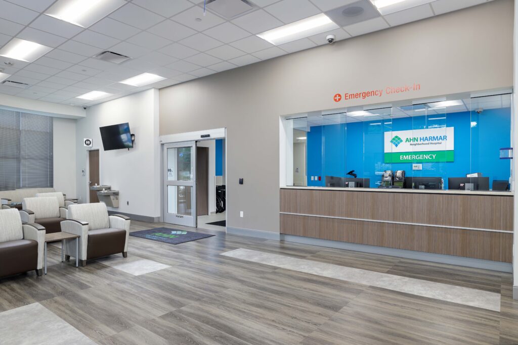 Waiting area and glass-enclosed emergency check-in desk at AHN Harmar Neighborhood Hospital.
