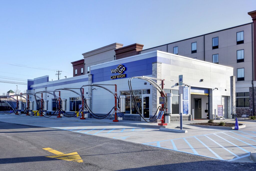 WetGo Car Wash building with exterior vacuum stations and parking spaces.