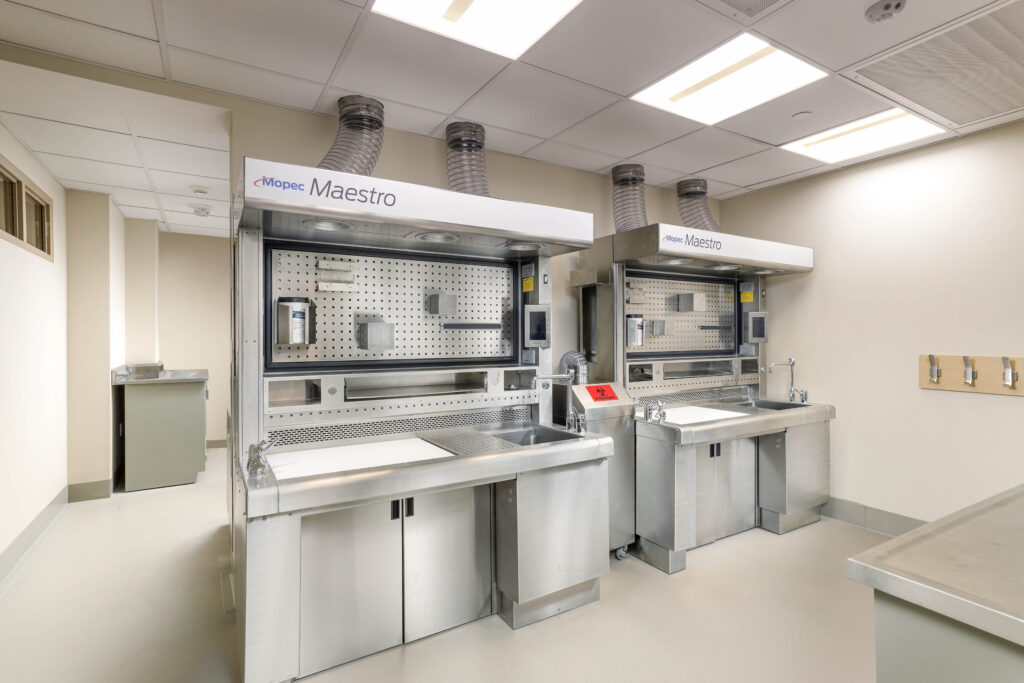 Two Mopec Maestro stainless steel grossing stations in a laboratory setting.