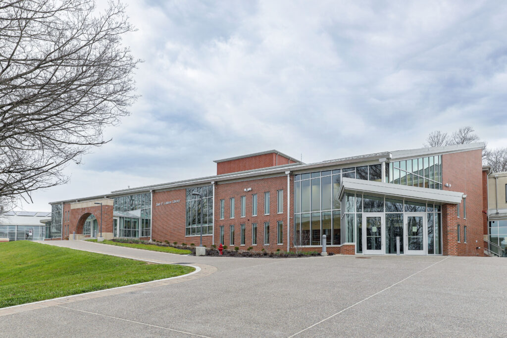 The exterior of the red brick Dale P. Latimer Library with large windows and a paved entrance.