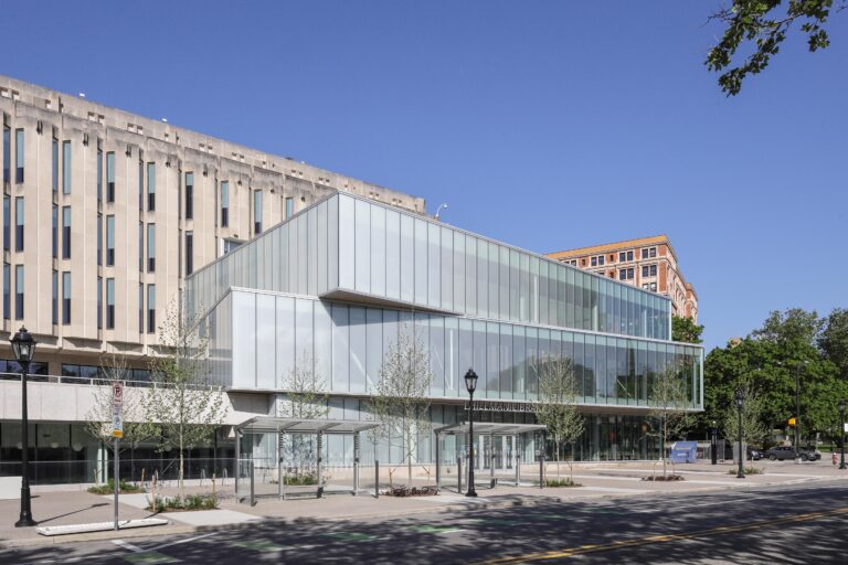 Exterior view of the Hillman Library, featuring a modern glass addition attached to a brutalist concrete building.