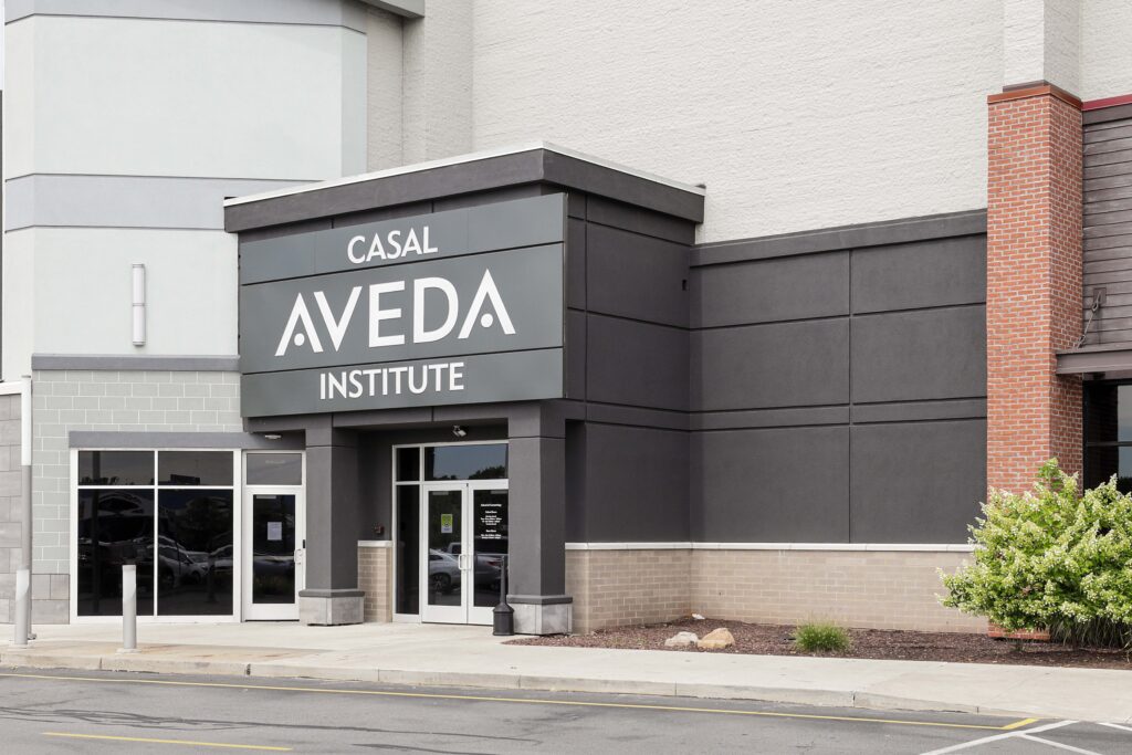 The exterior entrance of a Casal Aveda Institute building.