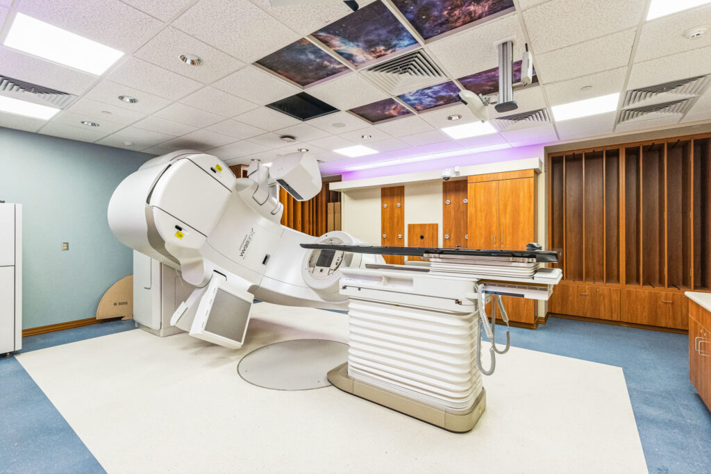 A Varian medical linear accelerator used for radiation therapy in a treatment room.