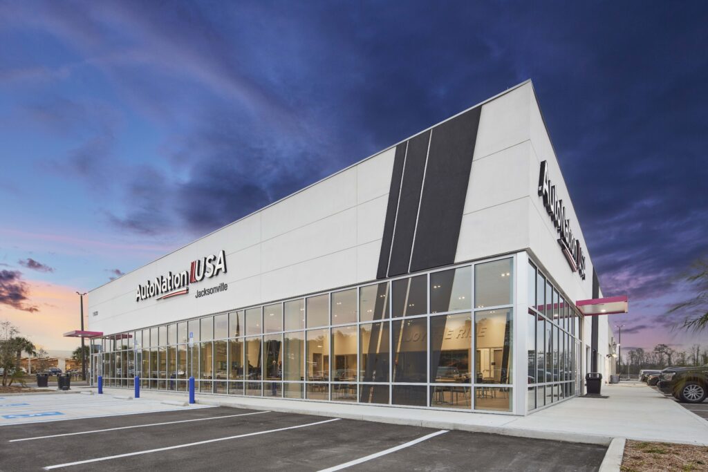 AutoNation USA Jacksonville dealership building at dusk.