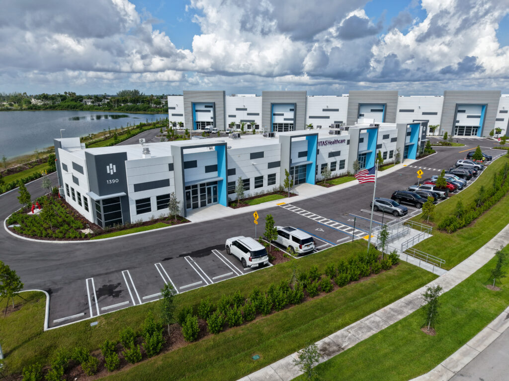 Aerial view of the Vitas Healthcare office building and parking lot next to a lake.