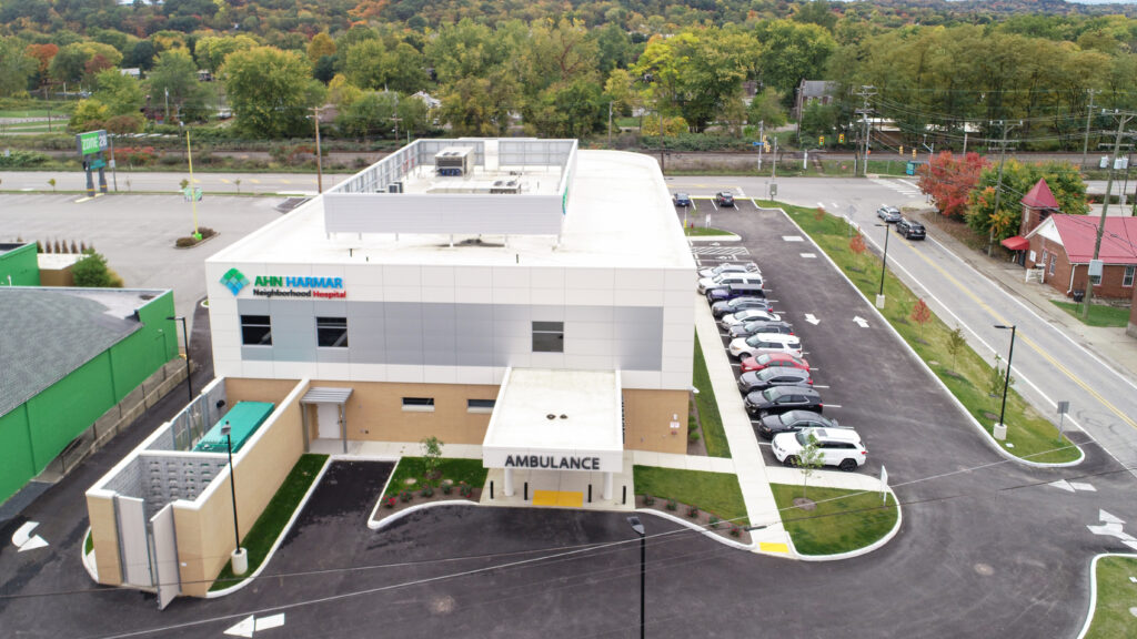 Aerial view of the AHN Harmar Neighborhood Hospital building with a parking lot and ambulance bay.
