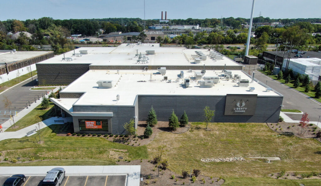 Aerial view of a Liberty Cannabis building with a parking lot and surrounding grounds.