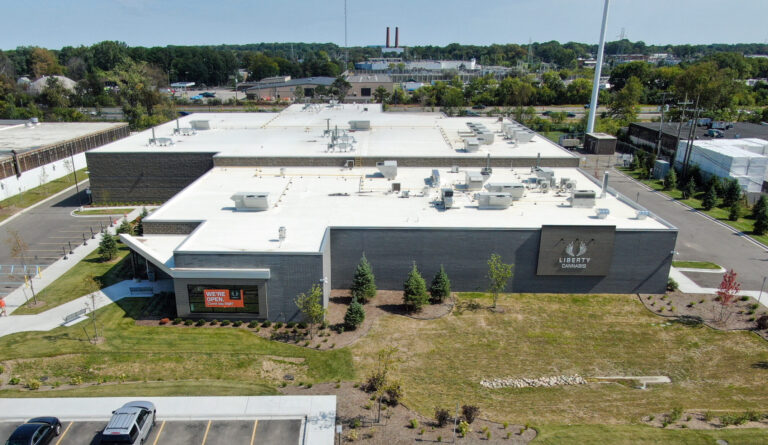 Aerial view of a Liberty Cannabis building with a parking lot and surrounding grounds.