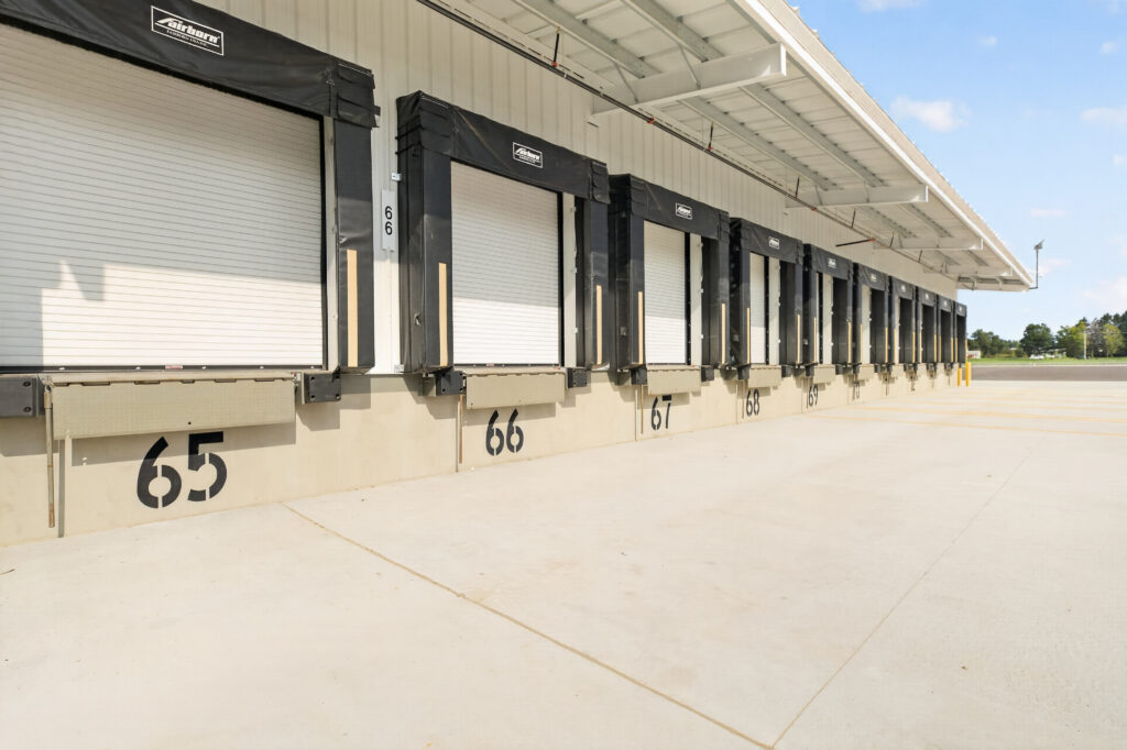 A row of warehouse loading dock bays numbered 65 through 72.