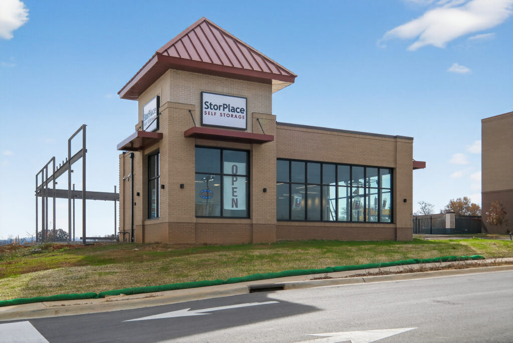 StorPlace Self Storage building with an “Open” sign in the window.