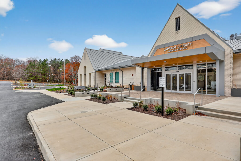 Exterior of the Laprade Library Harmon Building with a concrete walkway and entrance.