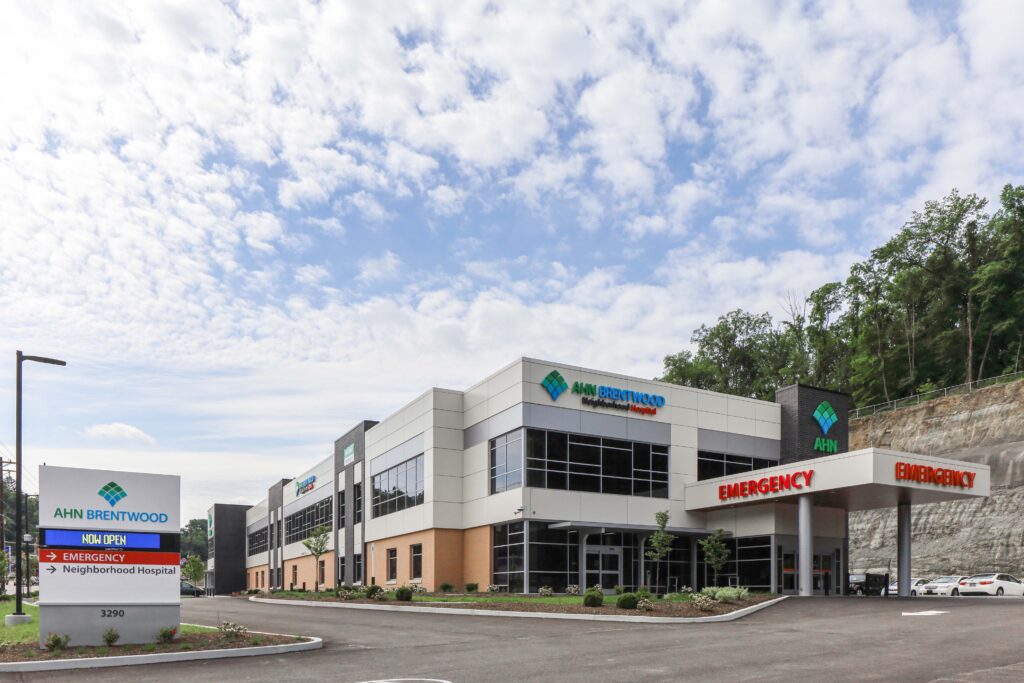 AHN Brentwood Neighborhood Hospital exterior with a signage pillar directing patients to the emergency department.