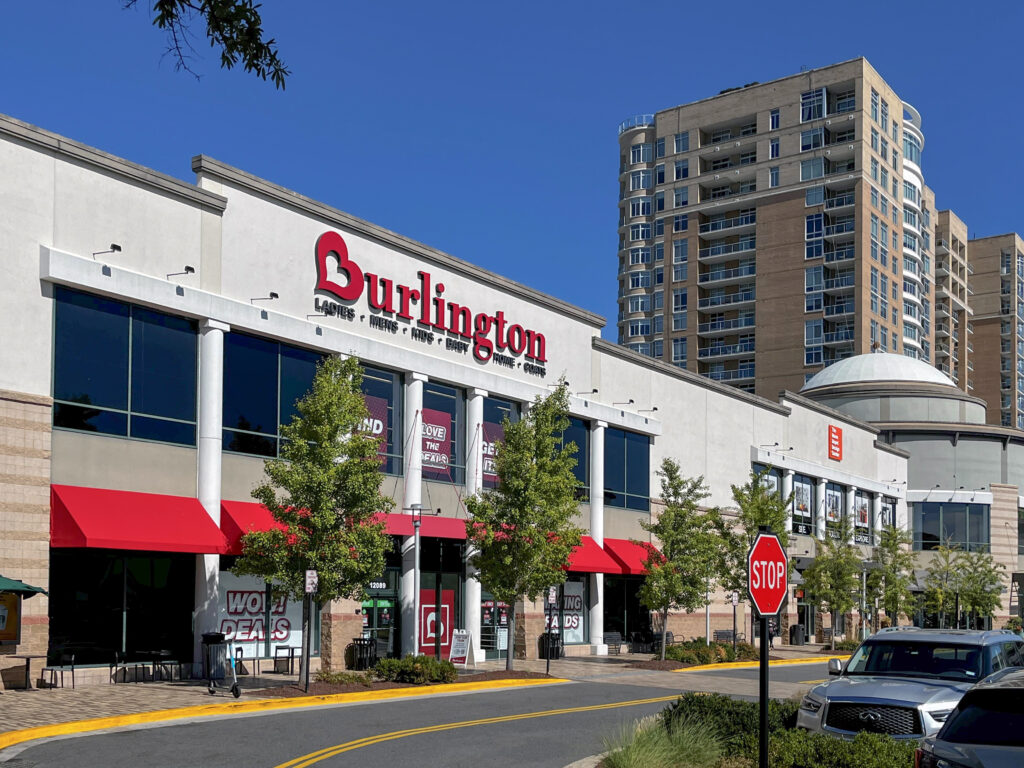 Burlington store exterior with red awnings and a stop sign in the foreground.