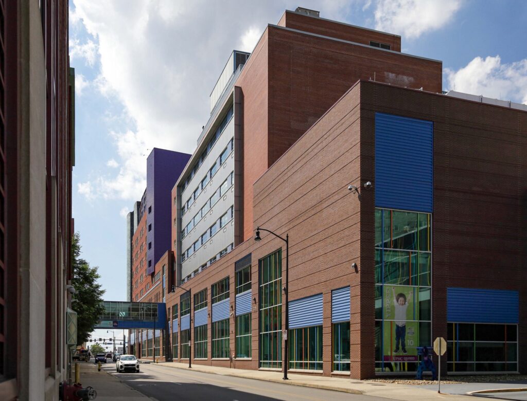 Modern brick medical center building viewed from a street-level perspective.