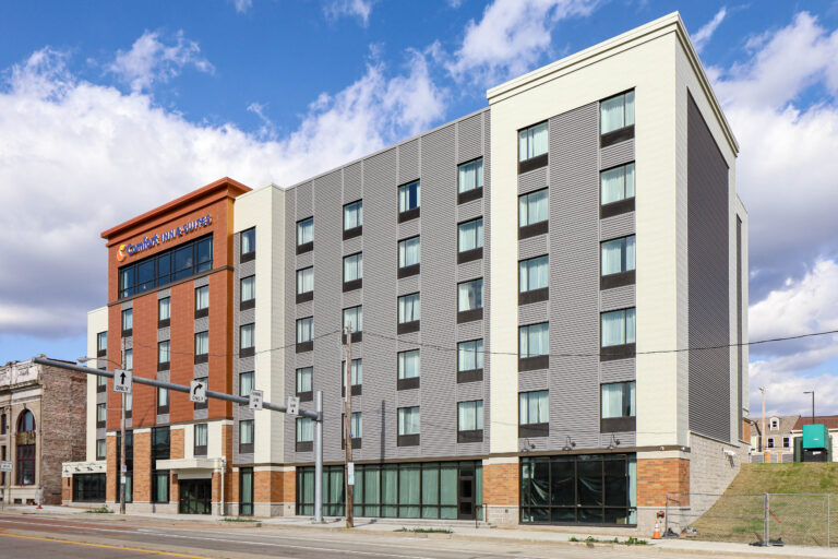 A five-story Comfort Inn & Suites hotel building viewed from the street.