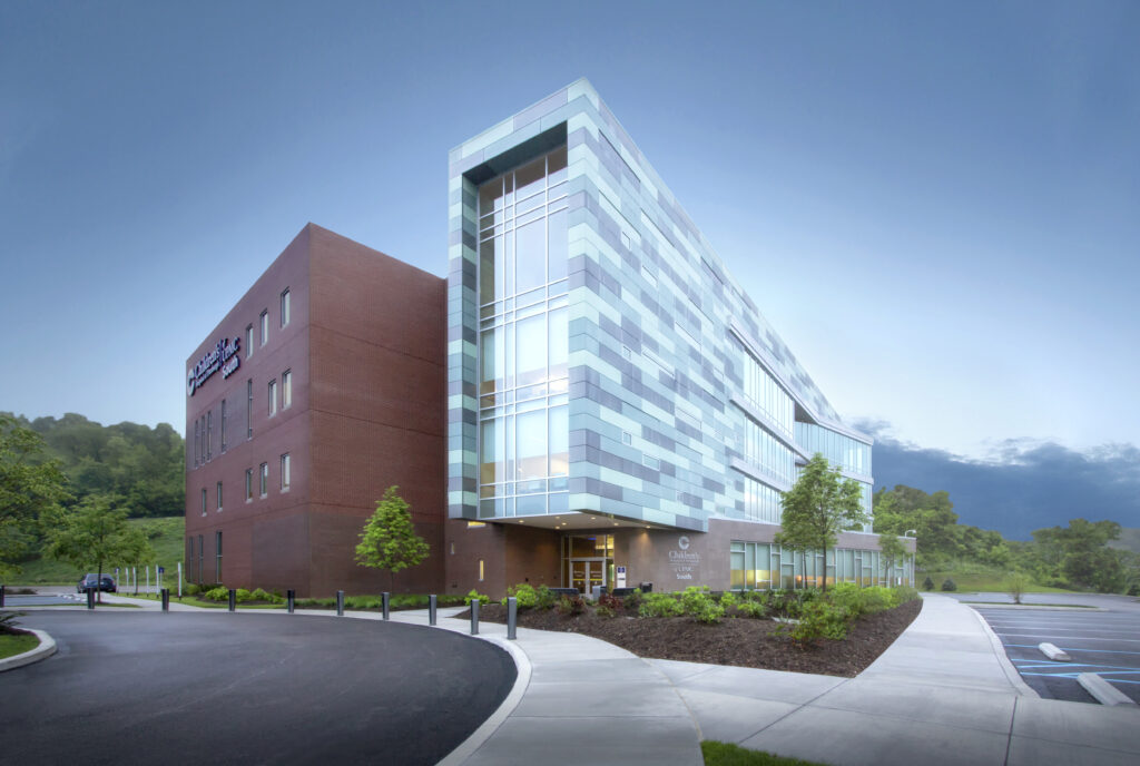 Children’s Hospital of Pittsburgh South building exterior with a red brick wing and a modern glass and blue panel wing.