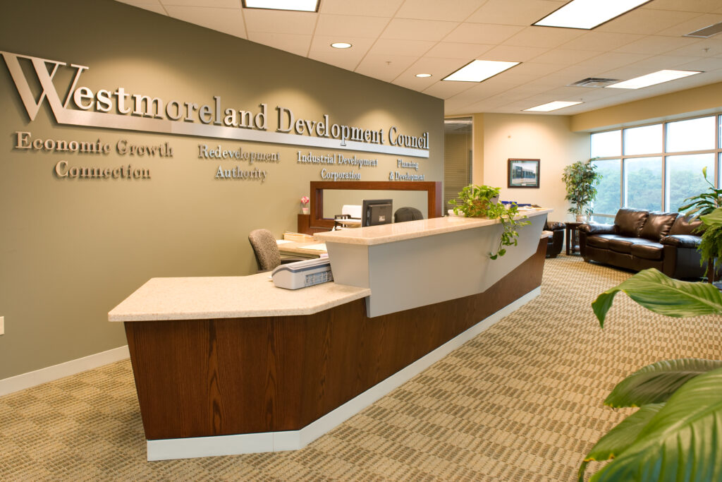 Reception area for the Westmoreland Development Council, featuring a long desk, office chairs, and lounge seating.