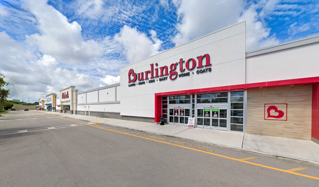 A Burlington store exterior in a strip mall, with other retail storefronts visible in the background.