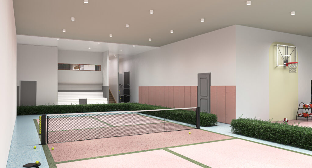 An indoor pickleball court with pink flooring, a net, bleachers, and a basketball hoop.