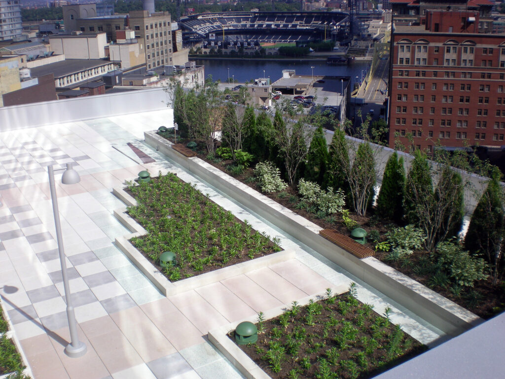 Rooftop terrace with tiered garden beds and a view overlooking PNC Park and the Allegheny River in Pittsburgh.