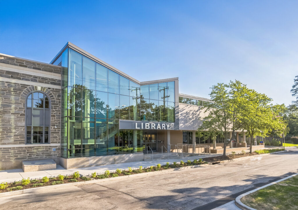 Exterior of a library building with stone walls and a modern glass entrance.