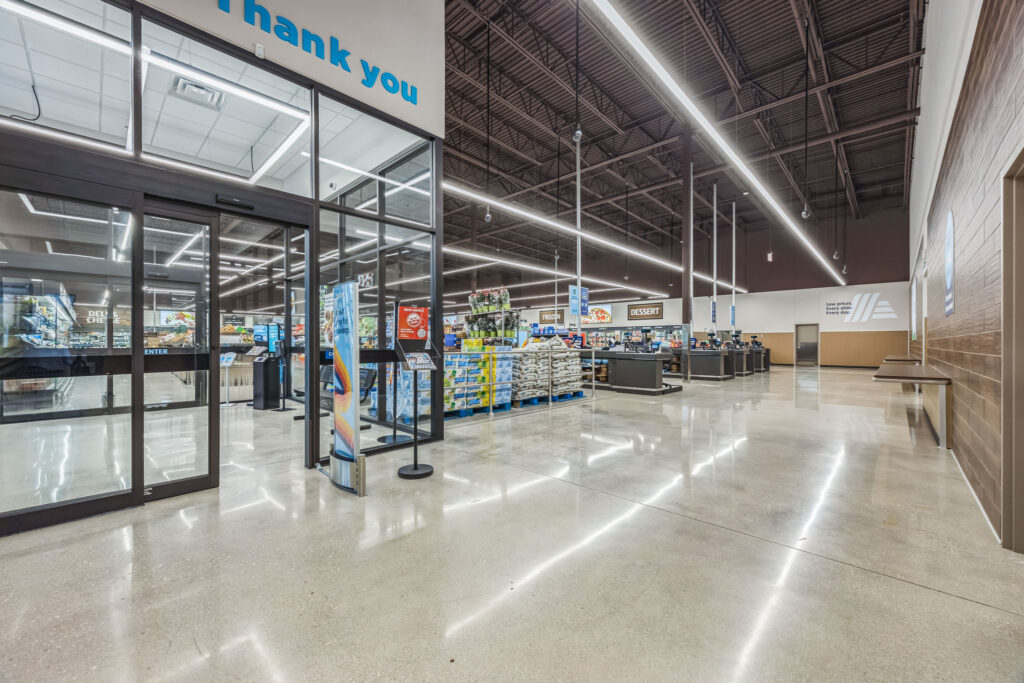 Interior view of an Aldi grocery store entrance looking toward the checkout counters.