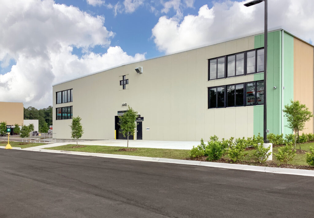 Exterior of a U-Haul storage facility building with the address 1445 marked above the entrance.