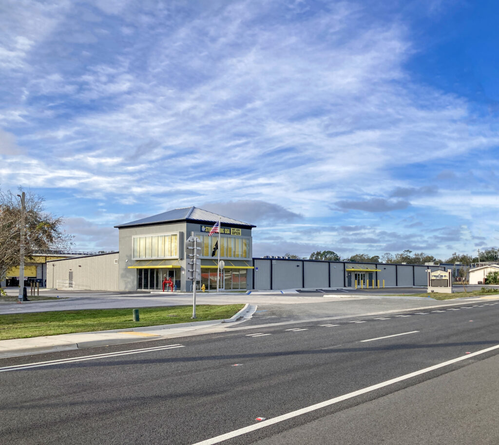 Storage King USA facility with a grey exterior, seen from across a paved road.