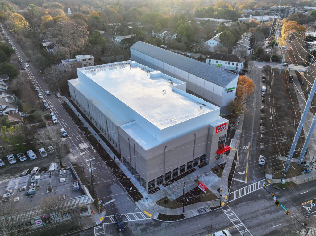 Aerial view of a multi-story Public Storage facility situated on a corner lot in a residential neighborhood.