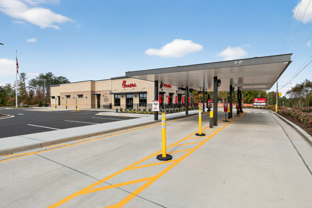 Exterior of a Chick-fil-A restaurant with a drive-thru lane and covered canopy.
