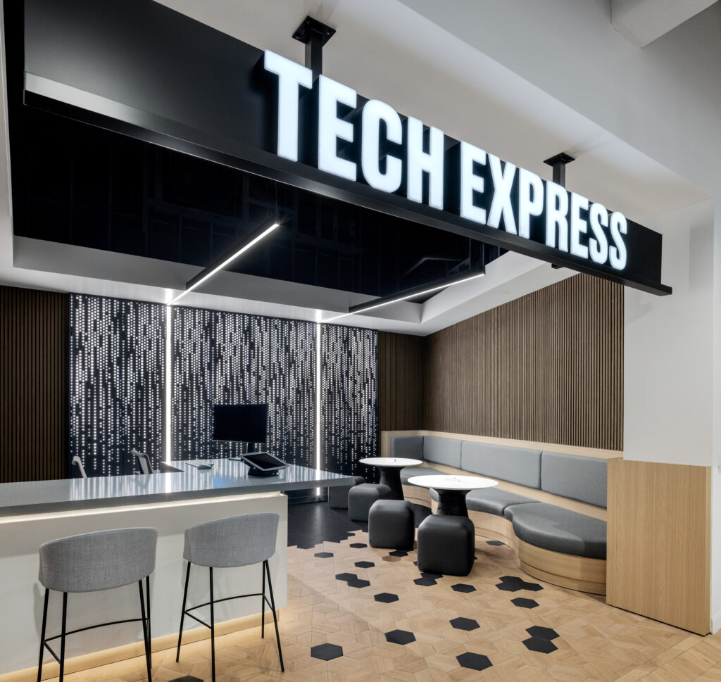 Tech Express storefront with a service counter, high-top stools, and a curved booth seating area.