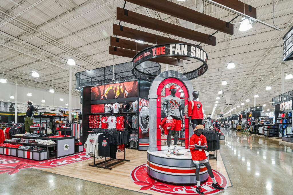 An Ohio State University-themed fan shop inside a retail store, featuring sports apparel on mannequins and racks.