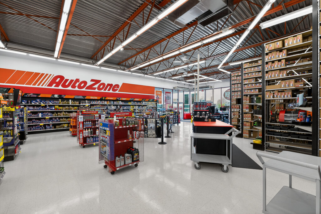 Interior of an AutoZone store featuring aisles of automotive parts and supplies on shelves and displays.