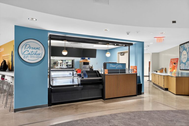 Dream Catcher Coffee Company kiosk with a refrigerated display case, counter, and branded signage.
