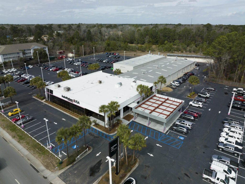 Aerial view of an AutoNation USA car dealership with a parking lot full of vehicles.