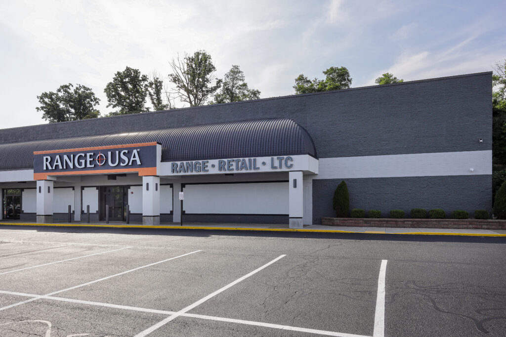 Exterior of a Range USA facility with a parking lot in the foreground.