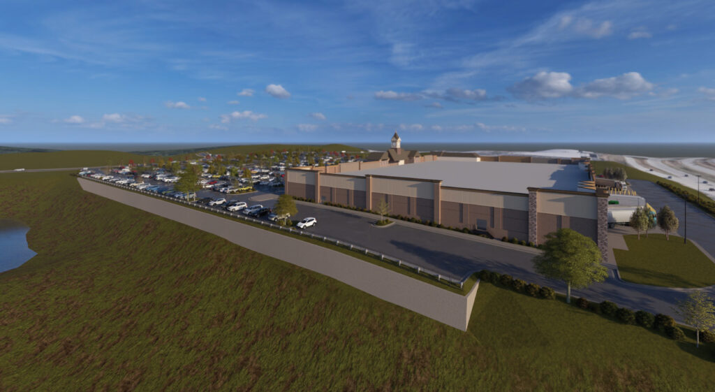 Architectural rendering of a large retail building with a clock tower and a full parking lot.