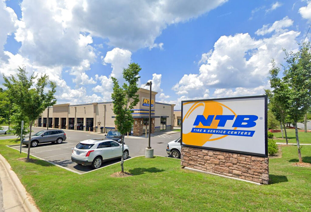 NTB Tire & Service Centers building and a large branded sign in the parking lot.
