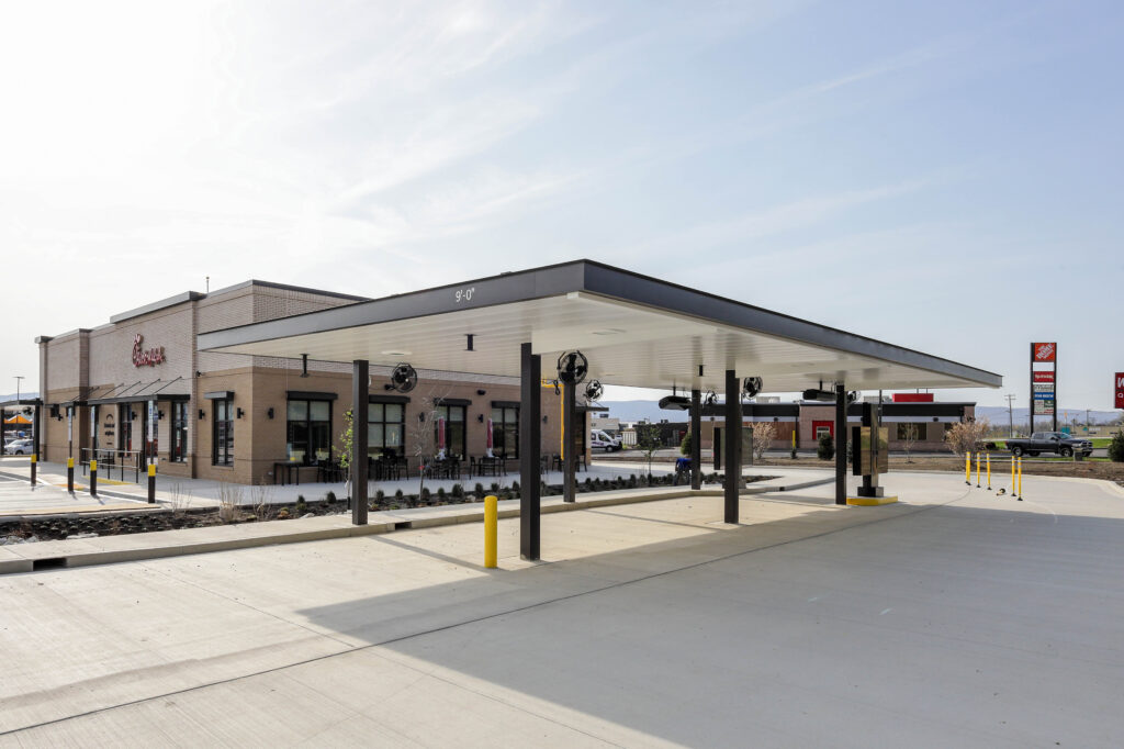 Chick-fil-A restaurant with a drive-thru lane covered by a metal canopy.