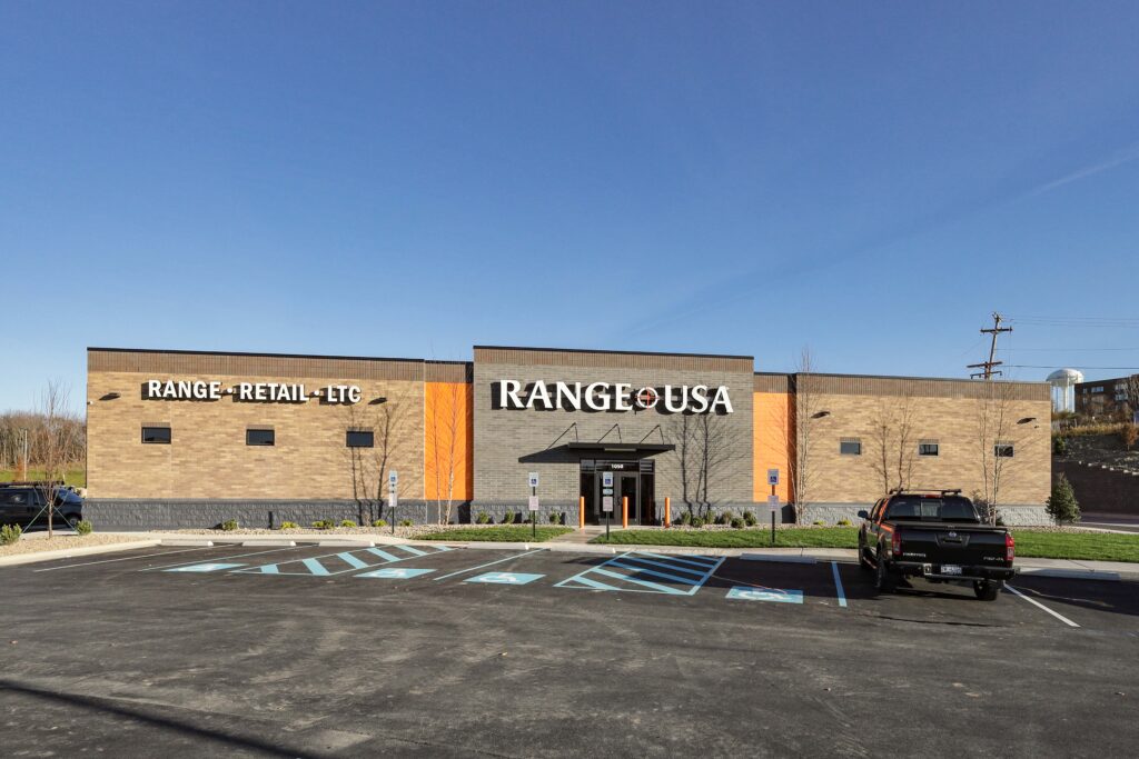Exterior of a Range USA building with a parking lot in the foreground.