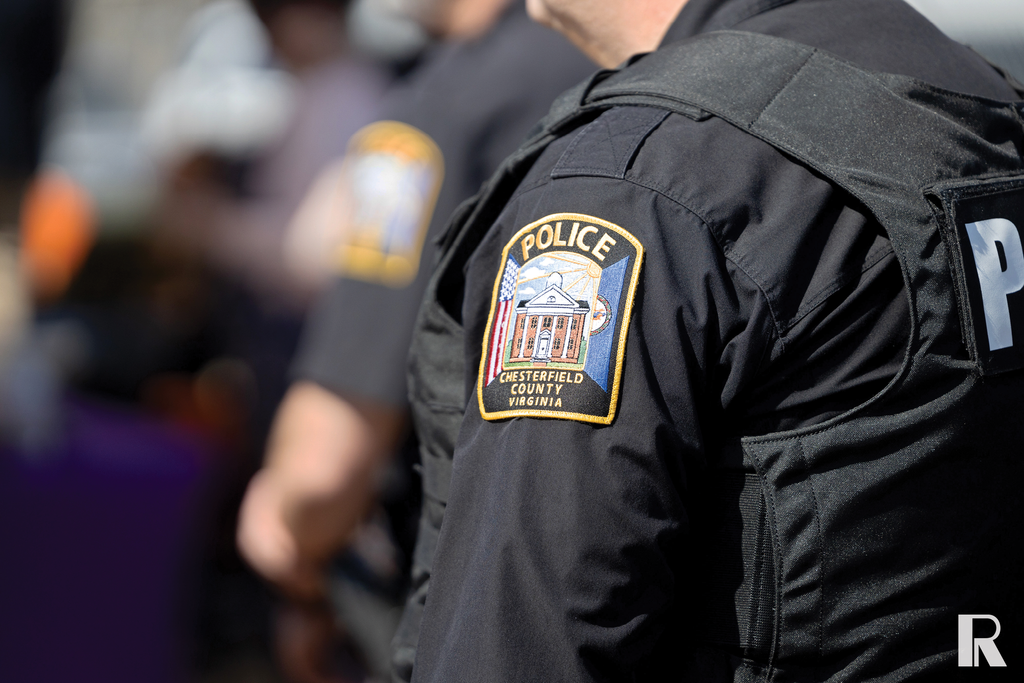 Police officer wearing a black uniform with a Chesterfield County Police patch on the sleeve.